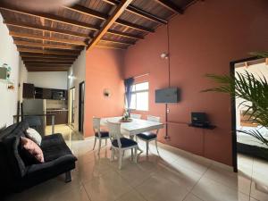 a living room with red walls and a table and chairs at Apartamento Relax in Medellín