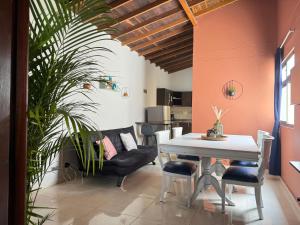 a dining room with a table and chairs and a plant at Apartamento Relax in Medellín