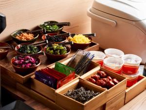 a table with bowls of different types of food at Daiwa Roynet Hotel Tsukuba in Tsukuba