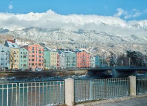 eine Stadt mit Brücke und Bergen im Hintergrund in der Unterkunft Chalet INN in Innsbruck