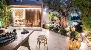 a patio with a table and chairs and a tree at Villa Steana in Makri