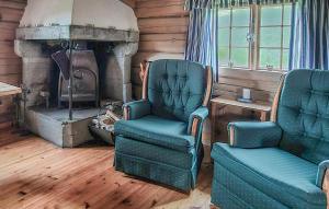 a living room with two chairs and a fireplace at 2 Bedroom Stunning Home In Sel in Rosti