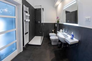 a bathroom with two toilets and a sink and a shower at Al Mare 54 Luxury Guest House in Lido di Camaiore +11 photos