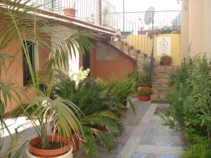 a courtyard with plants and stairs in a building at Guest House Il Giardino Segreto in Cagliari