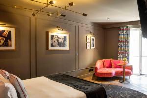 a bedroom with a bed and a couch and a chair at Upon Angels - Adults Only in Lisbon +69 photos