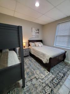 a bedroom with a bed and a nightstand and a bed sidx sidx sidx sidx at Lovely 5 Bedrooms, 3 Full Baths Home Near Parks! in Austell