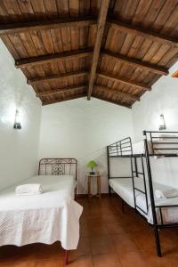 a bedroom with two bunk beds and a wooden ceiling at Quinta do lagar in Chamusca +61 photos