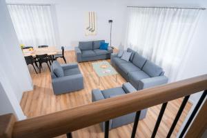 a living room with two couches and a table at Golf & Lake House 16 in Naterki