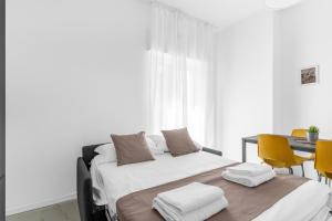 a bedroom with a bed with towels on it at MI CASA - Appartamento in Ponte Nuovo in Milan