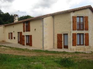 an old house with wooden doors and windows at La ferme d'ernest in Marnay