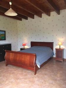 a bedroom with a bed and two tables with lamps at La ferme d'ernest in Marnay