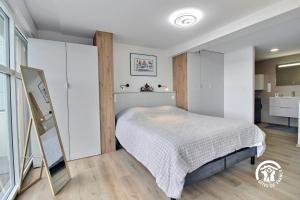 a bedroom with a bed and a bathroom at Les minahouets in Locmiquélic