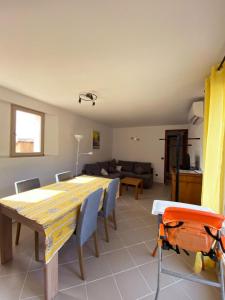 a dining table and chairs in a living room at Domaine des fouques in Hyères