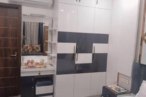 a bathroom with a black and white wall at The Great Escape - Rustic Countryside Stay in Amritsar
