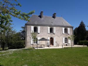 an old house with a gazebo in front of it at La charmille in Saint-Gaudens