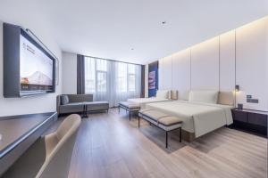 A bed or beds in a room at Atour Hotel Wuhan Optics Valley Plaza Nationalities University