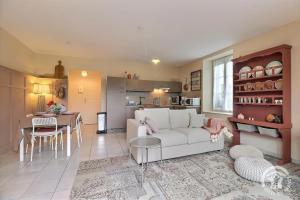 a living room with a white couch and a table at Les hortensias in Feins