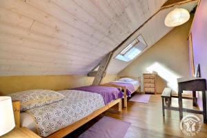 two beds in a room with a attic at La haie chapeau in Saint-Thurial
