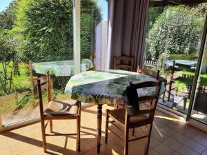 a table and chairs in a room with a window at Le chÂteau in Saint-Aignan