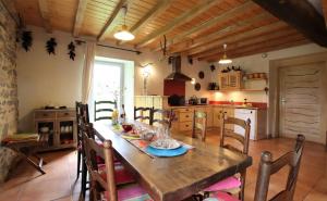 a kitchen and dining room with a wooden table and chairs at Bonnevigne in Lys