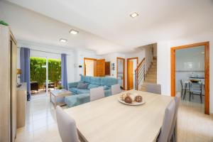 a dining room and living room with a table and chairs at Villa Paraíso in Alcudia