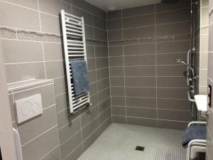 a bathroom with a shower with a blue towel at Le studio de saint-maixent le petit in Haims +9 photos