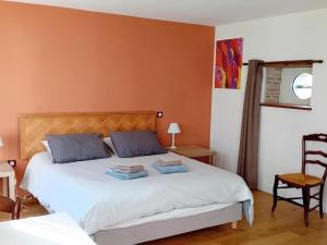 a bedroom with a bed with two pillows on it at Le studio de saint-maixent le petit in Haims