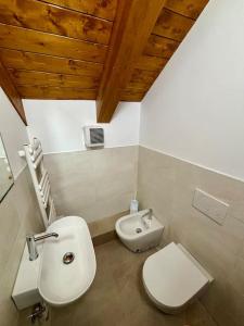 a bathroom with a toilet and a bidet and a sink at LAntica Torre in Pontebba +17 photos