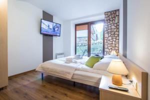 Posteľ alebo postele v izbe v ubytovaní Dolina Resort Zakopane