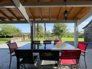 a dining table and chairs on a patio at Chez zézé in Asson