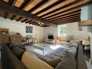 a living room with a couch and a table at Chez zézé in Asson