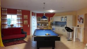 a living room with a pool table in it at Ferienwohnung Zinn in Rockeskyll