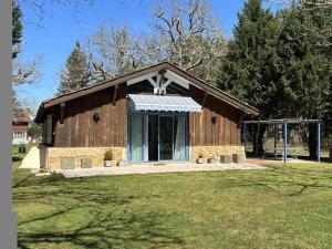 a large wooden building with a large window at Peyrot in Onesse-et-Laharie
