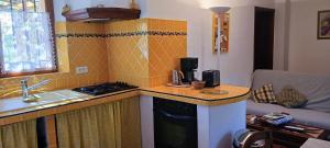 a kitchen with a sink and a counter top with a stove at Le gîte jaune à ampus in Ampus