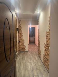 a hallway with a door and a brick wall at Квартира in Vanadzor +2 photos