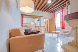 a living room with a couch and a table at Le bas du buisson fermé in Bucey-en-Othe