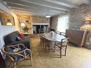 a living room with a table and a couch at Gîte jean in Horsarrieu