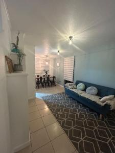 a living room with a blue couch and a dining room at Hotel Boutique Paqari casas completamente amobladas in Vallenar