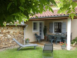 a patio with chairs and a table in front of a house at Gîte jean in Horsarrieu +13 photos