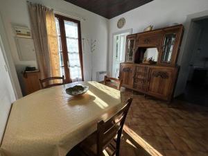 a dining room with a table and a dresser at Le moulin in Préchacq