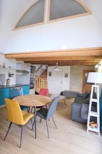 a living room with a wooden table and chairs at Gîte La Lauze de Marijoulet 2/4 personnes in Chanac