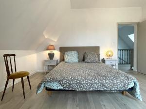 a bedroom with a bed and two tables and a chair at Lajus fontaine in Livron