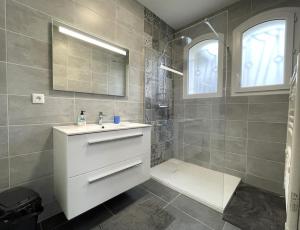 a bathroom with a sink and a shower at Lajus fontaine in Livron +27 photos