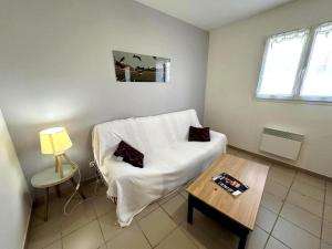 a living room with a white couch and a table at Gabardan in Mugron