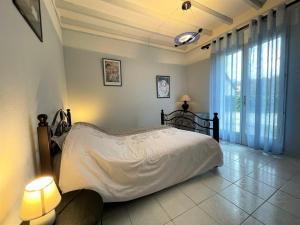 a bedroom with a bed with white sheets and two lamps at Beratarbide in Laroin