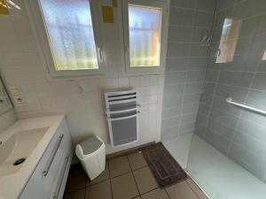 a white bathroom with a sink and a shower at Gabardan in Mugron +8 photos