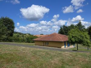 a small house in a field next to a road at Gabardan in Mugron