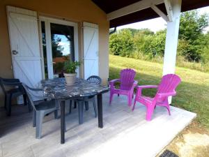 a table and four chairs on a patio at Marensin in Mugron