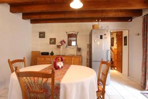 a kitchen with a table with a cat sitting on it at Cauhape in Auga