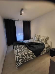 a bedroom with a bed and a window with black curtains at Cristina Residence - App 1 in Staden